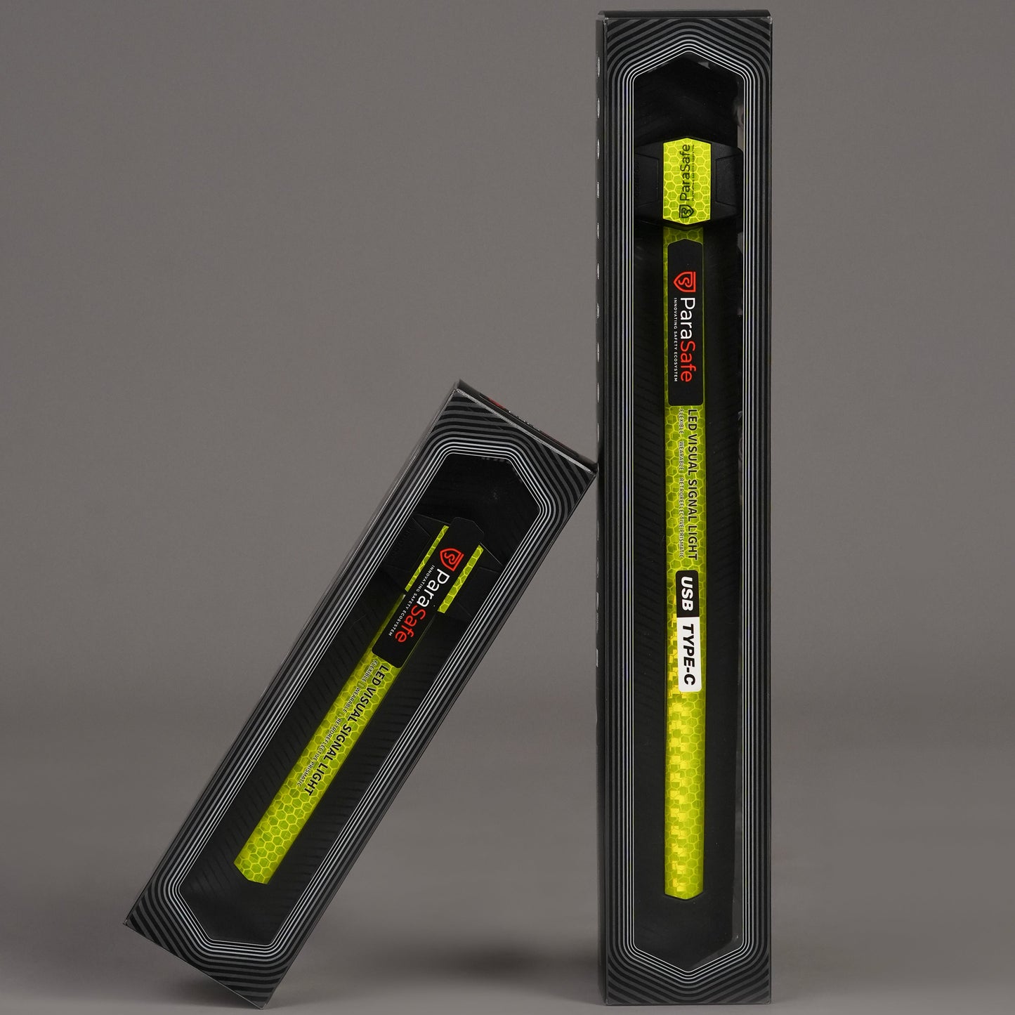 Two ParaSafe Green LED Wearable strips in packaging on a gray background